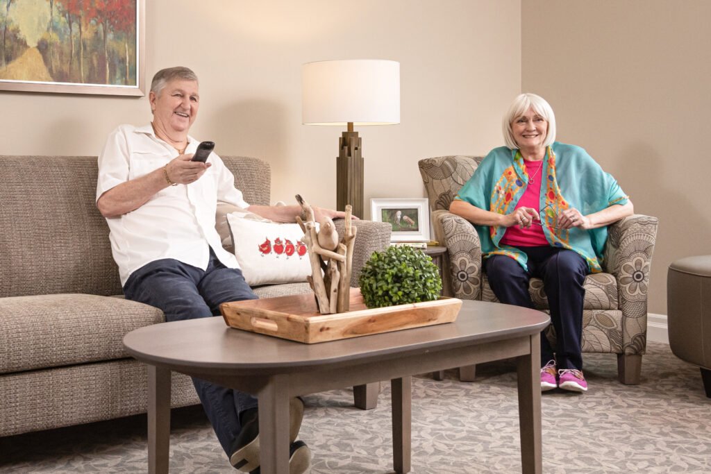 Seasons Residents Laughing While Watching Television in Their Suite