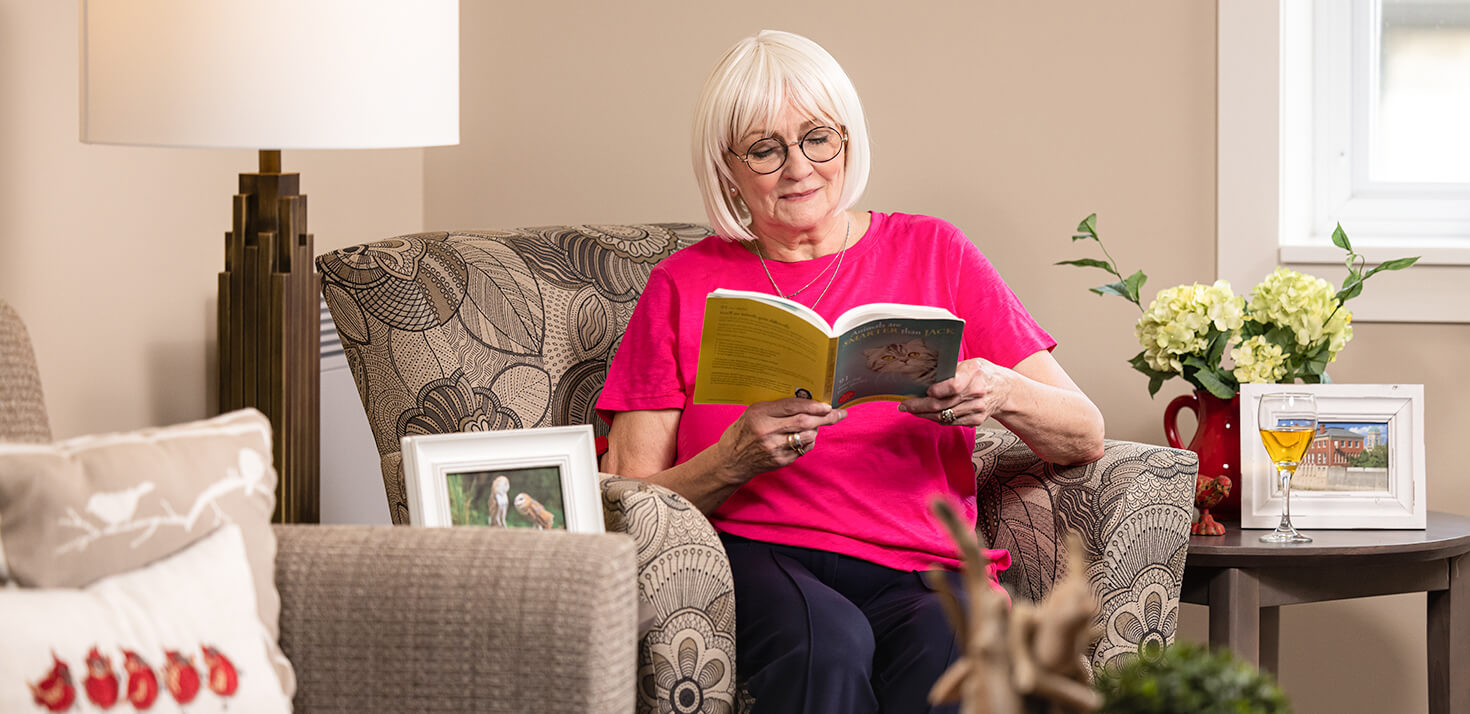 Elderly women reading a book in a senior living community