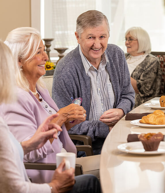 Elderly talking over breakfast in a senior living community