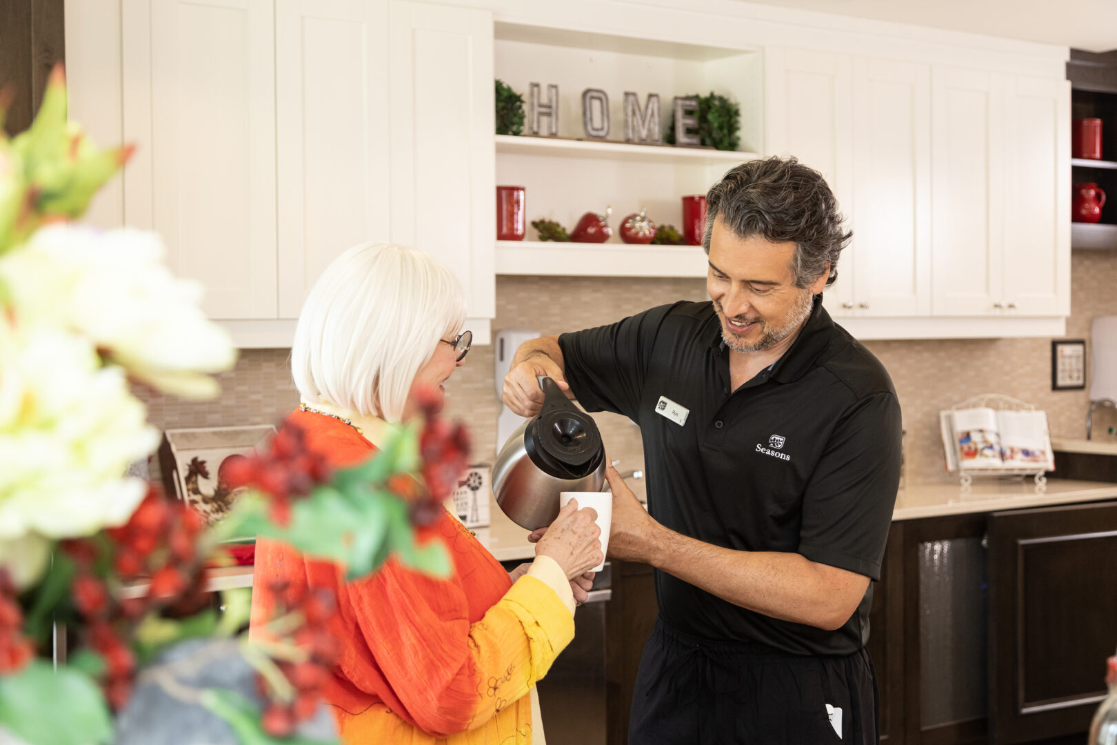 Seasons Team Member Pouring Coffee for Resident in Common Area