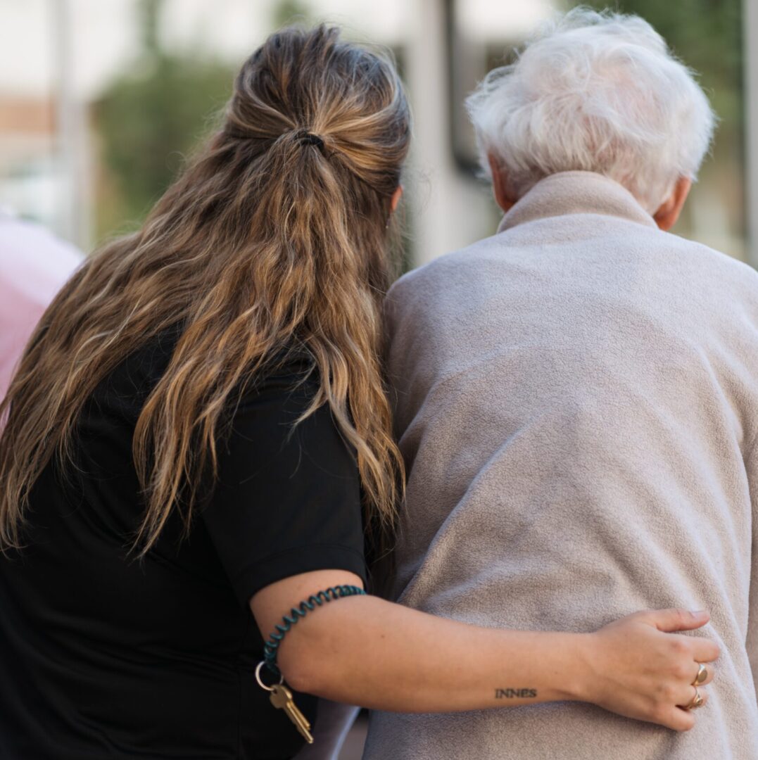 Seasons team member helping resident