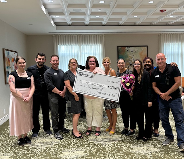 Seasons London presents Karens Place with $10,000 cheque and food bank donations.